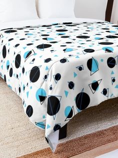 a bed with a blue and black bedspread on it