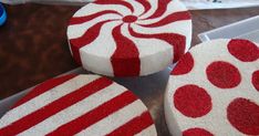 three red and white striped cakes sitting on top of a table next to each other