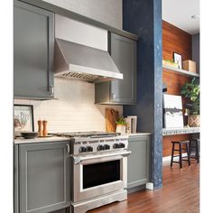 a kitchen with gray cabinets and white appliances