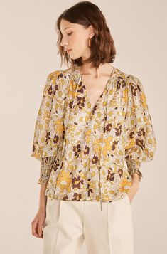 Fresh blooms in jadeite and golden yellow complement the feminine, smock-trimmed sleeves on this slightly sheer, floaty voile blouse. Feminine Shirts, Co Ords Outfits, Blouse Images, Knit Gown, Feminine Wardrobe, Voile Dress, Pleated Sleeves, Tie Front Blouse, Passion Flower