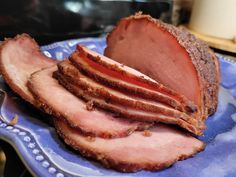 sliced ham sitting on top of a blue plate