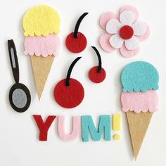 the word yum spelled out with felt ice creams and cherries