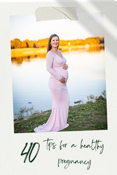 a pregnant woman in a pink gown standing next to a body of water with the words 40 tips for a healthy pregnancy