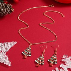 Decorate yourself in seasonal shine with this Christmas tree jewelry set complete with a necklace and earrings made from colorful enamel and 18k gold plating for holiday-ready accessorizing. Includes one pendant necklace and one pair of drop earrings Necklace: 15.75" L with 1.97" extender (chain); 0.71" W x 1.3" L (pendant) Earrings: 0.71" W x 1.89" L Lobster claw clasp 18k gold-plated copper / enamel Christmas Tree Jewelry, Christmas Tree Necklace, Tree Jewelry, Jewelry Christmas Tree, Tree Necklace, Holiday Ready, Jewelry Tree, Earring Sale, Necklace And Earrings