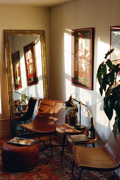 a living room filled with furniture and paintings on the wall