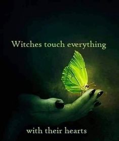 a woman's hand holding a green butterfly with the words witches touch everything with their hearts