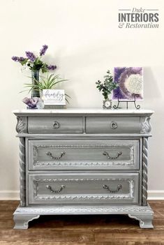 an old dresser with some flowers on top