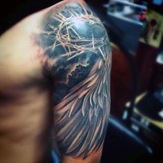 a man's arm with an angel tattoo on it