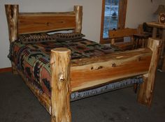 a bed made out of wooden logs in a room with carpeted flooring and walls