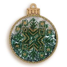 a christmas ornament with green beads and gold trimmings on a white background