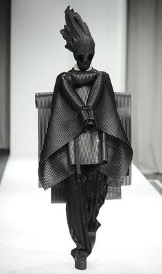 a black and white photo of a woman's dress on the catwalk at a fashion show