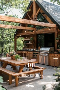 an outdoor kitchen with picnic table and grill