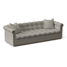 a gray couch with pillows on top of it