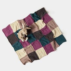 an elephant is sitting on top of a patchwork blanket that has been made into a quilt