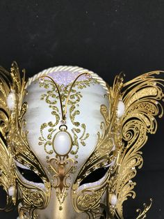 Venetian Mask for decoration - Traditional and original papier-mache Venetian mask, handmade and decorated with metal insert, gold-leaf and glitters,enriched with Swarovski crystals. Dimension::Hight 31cm,width 24cm Decoration only,not wereable All our masks are handmade papier-machè masks made in Venice. Our decorators use techniques typical of the Venetian tradition such as stucco, acrylics, gold and silver-leaf, macramè, passementerie, glitters and crequelè to offer you a wide range of origin Gold Masks For Evening Carnival, Gold Mask For Mardi Gras Evening, Elegant Gold Mask For Masquerade, Gold Carnival Masks For Evening, Gold Masks For Mardi Gras Evening, Gold Masks For Mardi Gras Evening Events, Elegant Gold Mardi Gras Masks, Gold Venetian Masquerade Mask For Evening, Gold Venetian Masquerade Mask For Formal Occasions