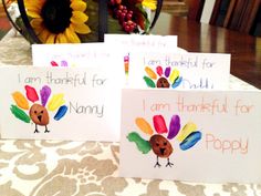 three thanksgiving cards on a table with flowers in the background