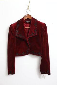 Elevate your style with this stunning Rare New J. Peterman velvet bolero jacket. The rich red color and intricate embroidered accents make it perfect for any occasion, from casual to formal. The long sleeves and collared neckline provide added warmth during the fall and winter seasons. This vintage piece is made with high-quality cotton velvet and lined with acetate for a comfortable fit. The short jacket length and solid pattern give it a classic, preppy vibe that is perfect for city or travel wear. Whether you're looking for a statement piece for a party or cocktail event, or simply want to add some designer flair to your workwear, this bolero jacket is sure to impress. Red And Gold Clothes, Drummer Oc, Jackets Aesthetic, Velvet Jacket Outfit, Velvet Jacket Women, Velvet Jackets Women, Velvet Bolero, Red Velvet Jacket, Red Clothes