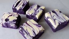 four pieces of purple and white swirled cake