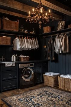 a washer and dryer in a room with dark wood paneling, chandelier hanging from the ceiling