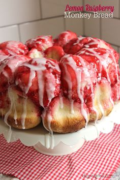 a strawberry bundt cake with icing drizzled over it on a plate