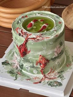 a green cake with red flowers on it