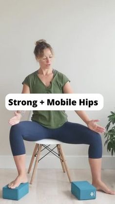 a woman sitting on top of a chair while holding her hands out to the side