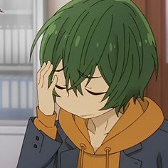 an anime character with green hair holding his hand to his face