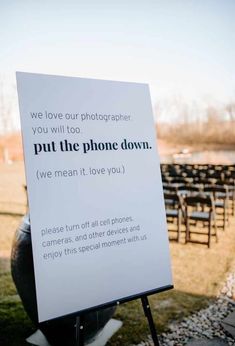 a sign in front of rows of chairs that read, we love our photographer you will too put the phone down we mean it love you