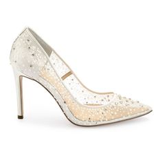 a pair of white high heels with pearls on the toe and heel, all covered in sequins