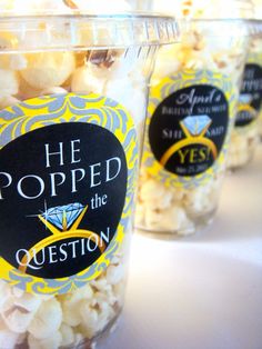 three plastic cups filled with popcorn sitting on top of a table