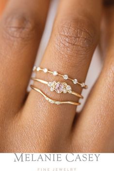 a close up of a person's hand with a ring on it and the words melanie casey fine jewelry