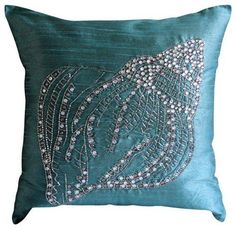 a blue pillow with silver beads on it