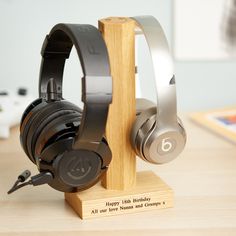 headphones are sitting on a wooden stand with the words happy birthday all over it