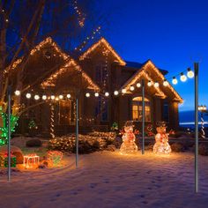 christmas lights decorate the front yard of a house