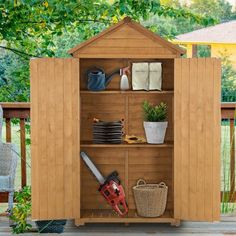 an outdoor storage shed with gardening tools on it