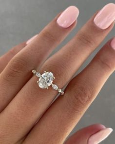 a woman's hand with a diamond ring on it