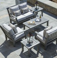 an outdoor patio furniture set with grey cushions