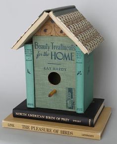 a bird house sitting on top of three bookends next to each other with the words beauty treatments for the home written on them