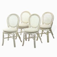 four white chairs with cane back and upholstered seat, all in different styles