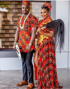 an african couple dressed in red and gold