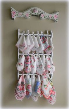 there are many pairs of socks hanging on the wall next to a rack with one pair of slippers