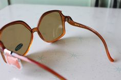 "1970s RARE Deadstock Sunglasses Glass Lenses- Impact Resistant Sticker still on lens Wonderful vintage condition Very rare deadstock Tinted Lens as seen in picture non-prescription amazing style Made in Taiwan 5.5\"total width 2 1/2\"lens width 5 1/4\"arms length Thank YOU and please feel free to ask me any ?s:) Have a lovely day xoxo www.etsy.com/shop/retroandme **on cardboard stand" Vintage Brown Sunglasses For Summer, Retro Brown Sunglasses With Uv Protection, Retro Brown Sunglasses With Mirrored Lenses, Cardboard Stand, Womens Eyewear, Girl Sunglasses, 4 Arms, Cool Pops, Mod Girl