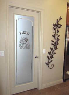 a door with an iron plant on it and the word pantry painted on it's side