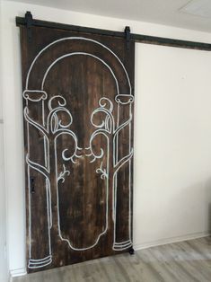 a large wooden door with an intricate design painted on it