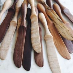 several wooden spoons lined up on a table