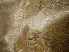 an image of a gold wallpaper with intricate designs on it's side and back