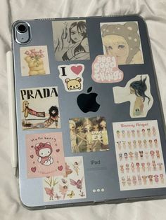 an apple laptop with many stickers on it