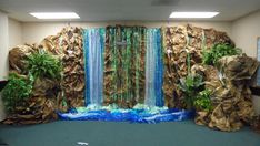 an office cubicle with a waterfall and plants