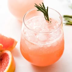 grapefruit, watermelon and rosemary garnish cocktails on a white surface