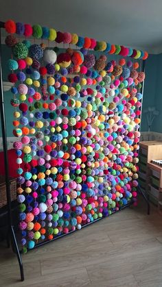 the colorful balls are hanging on the wall